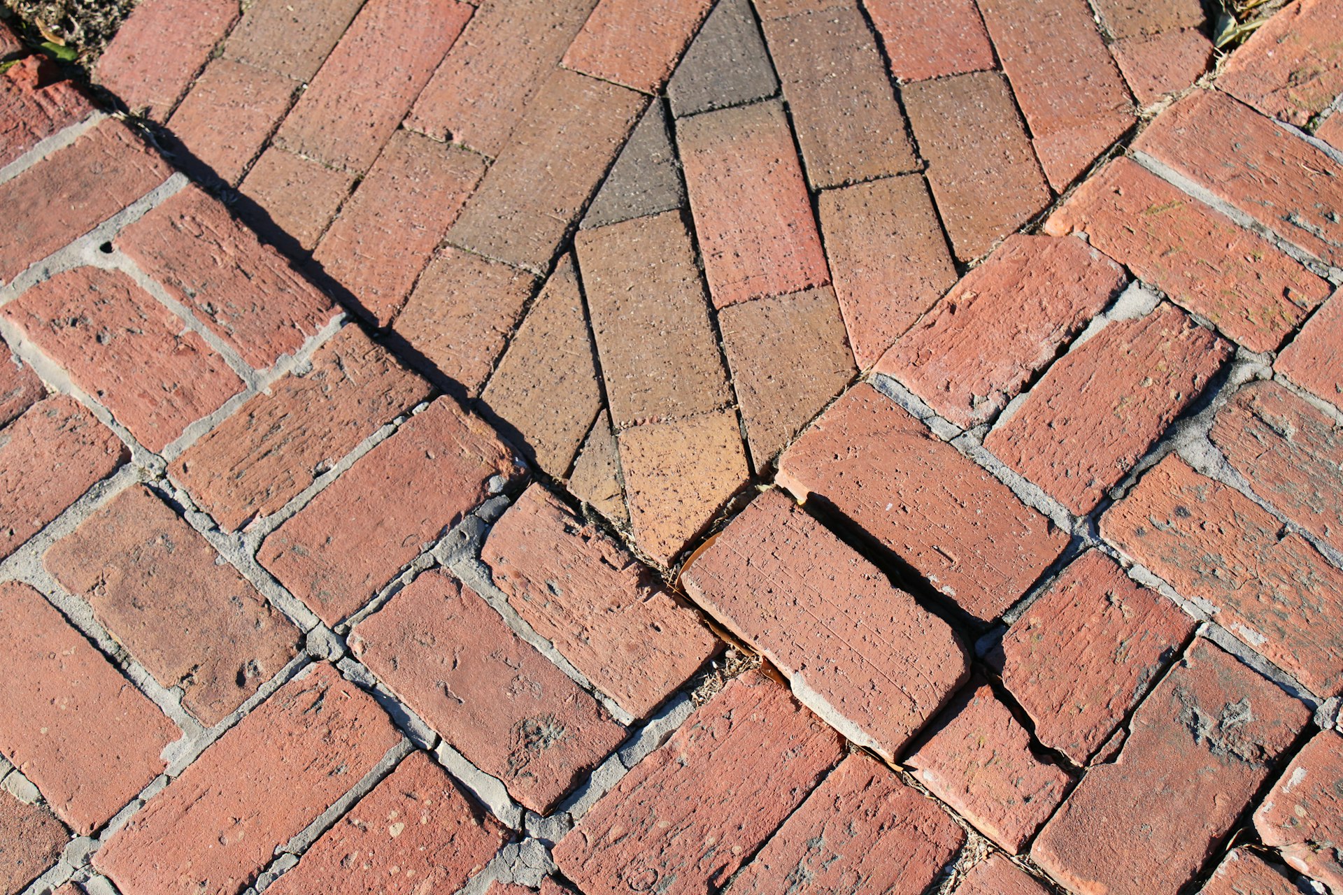 a close up of a red brick sidewalk